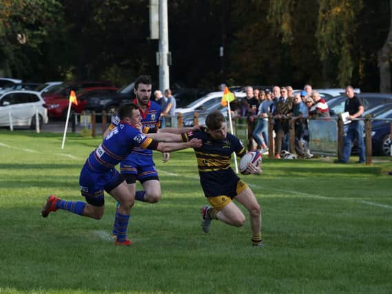 OLs' Jonny Ure heads to the line for a try