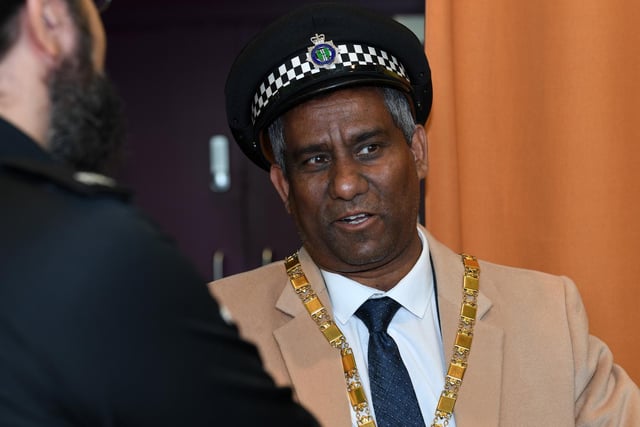 MK Mayor Cllr Mohammed Khan tries on a police hat for size at the Thames Valley Police display stand