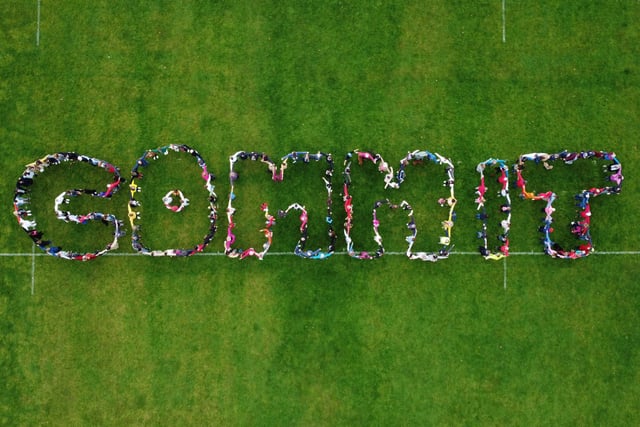 Local residents made a human sign spelling the word 'commit' to demonstrate their commitment to protecting the environment. Picture by Dan Hill