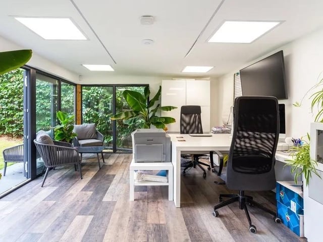The lawn leads down to a summer house with power and heating. Picture: Hamptons - Haywards Heath Sales.