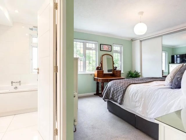 The main bedroom has extensive built-in storage and a contemporary en suite bathroom. Picture: Hamptons - Haywards Heath Sales.
