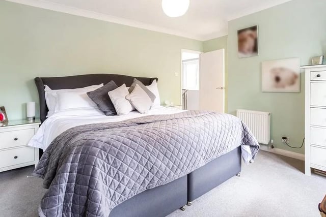 The main bedroom has extensive built-in storage and a contemporary en suite bathroom with overhead waterfall shower and twin basins. Picture: Hamptons - Haywards Heath Sales