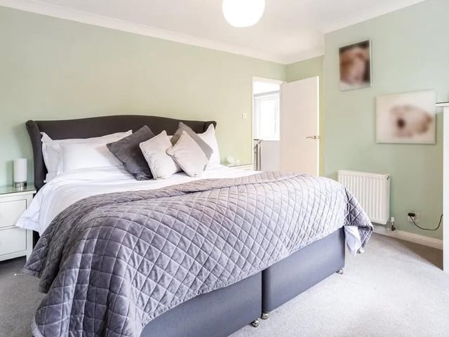 The main bedroom has extensive built-in storage and a contemporary en suite bathroom with overhead waterfall shower and twin basins. Picture: Hamptons - Haywards Heath Sales