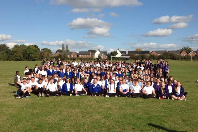 Year 6 youngsters smile for the camera at the Tag Rugby Festival which saw almost 800 children enjoy the event organised by the Harris CofE Academy School Sports Partnership
