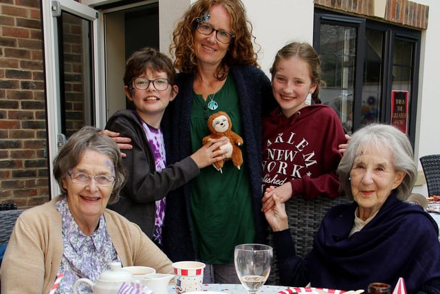 Generations of families were reunited at Beechwood Grove care home’s intergenerational day, which brought all the fun of the fair to Eastbourne.  Fire-eating, face-painting and card tricks were among the entertainment on offer at the event, which was the first of its kind to take place after lockdown restrictions had been lifted. Pictured here is resident Corrie Paxton with Hazel Goldreich and her grandchildren Jack age nine, Rosie, 10, and daughter-in-law Natasha, SUS-211029-105400001