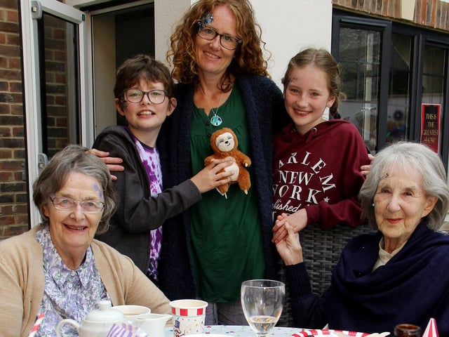 Generations of families were reunited at Beechwood Grove care home’s intergenerational day, which brought all the fun of the fair to Eastbourne. Fire-eating, face-painting and card tricks were among the entertainment on offer at the event, which was the first of its kind to take place after lockdown restrictions had been lifted. Pictured here is resident Corrie Paxton with Hazel Goldreich and her grandchildren Jack age nine, Rosie, 10, and daughter-in-law Natasha, SUS-211029-105400001