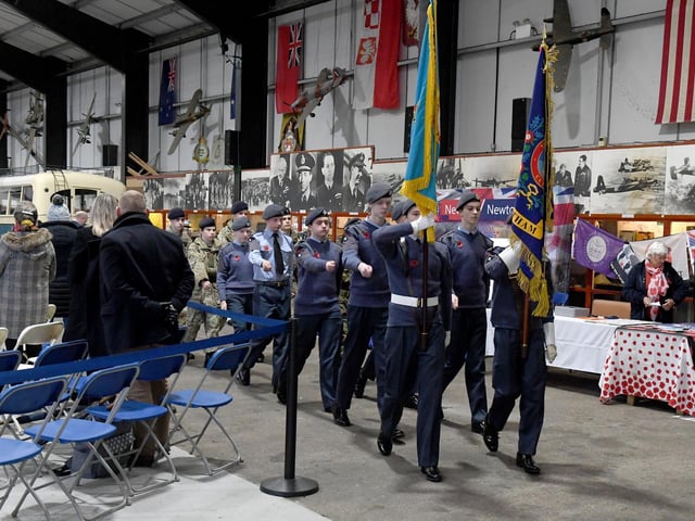 Members of the county's youth groups parade their standards.