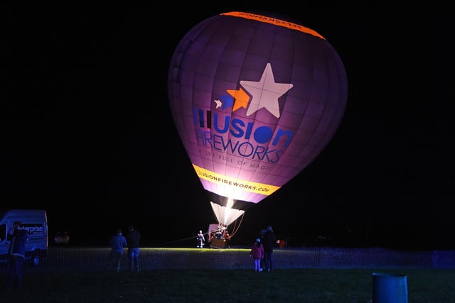 A hot air balloon inflates on the show ground before the firework display.