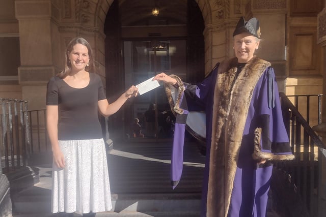 Laura Richmond, who came third  in the Leamington in Bloom annual photography competition. She is pictured receiving her cheque from Leamington Mayor Cllr Susan Rasmussen.