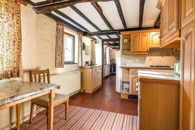 The kitchen and breakfast room is fitted with traditional wooden cupboards and has an integral larder and wine cupboard. Picture: Jackson-Stops Lindfield.