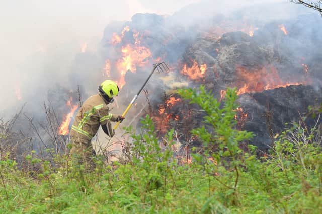 A large haystack remains alight on a farm on Whiteway, Alfriston, with crews still on scene to ensure a controlled burning takes place. Photo: Dan Jessup SUS-210511-075727001