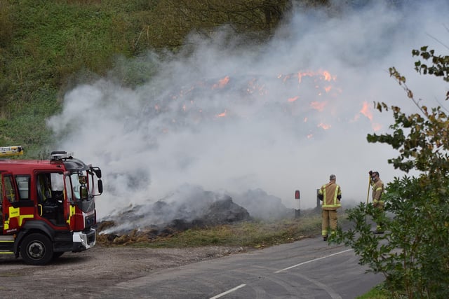A large haystack remains alight on a farm on Whiteway, Alfriston, with crews still on scene to ensure a controlled burning takes place. Photo: Dan Jessup SUS-210511-075704001