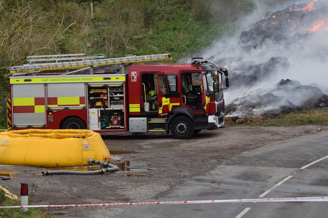 A large haystack remains alight on a farm on Whiteway, Alfriston, with crews still on scene to ensure a controlled burning takes place. Photo: Dan Jessup SUS-210511-075547001