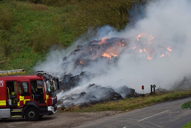 A large haystack remains alight on a farm on Whiteway, Alfriston, with crews still on scene to ensure a controlled burning takes place. Photo: Dan Jessup SUS-210511-075518001