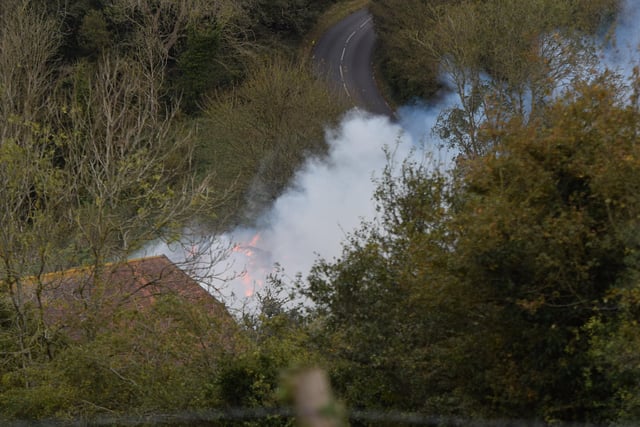 A large haystack remains alight on a farm on Whiteway, Alfriston, with crews still on scene to ensure a controlled burning takes place. Photo: Dan Jessup SUS-210511-075621001