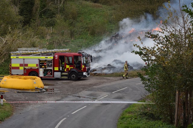 A large haystack remains alight on a farm on Whiteway, Alfriston, with crews still on scene to ensure a controlled burning takes place. Photo: Dan Jessup SUS-210511-075633001