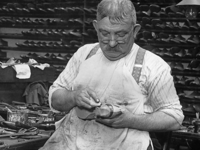 16th October 1936: A man works on a pair of shoes with scooped-out heels for actress Marlene Dietrich, at a Northampton factory. (Photo by Fred Morley/Fox Photos/Getty Images)