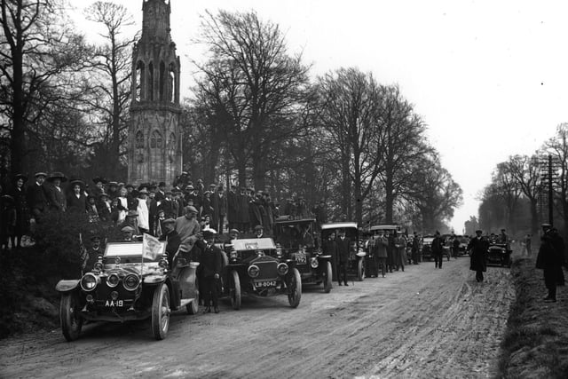 22nd April 1910: Motor cars and spectators at Queen Eleanor's Cross, Northampton, on the 10th anniversary of the 1,000 miles trial. Lord Montague is in the car on extreme left. (Photo by Topical Press Agency/Getty Images)