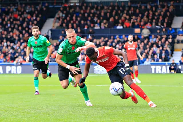 Elijah Adebayo tries to get away from Stoke defender Leo Ostigard