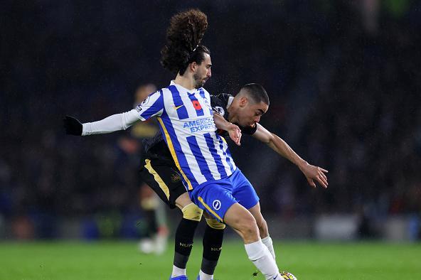 The Albion left back tussles for possession against Miguel Almiron of Newcastle