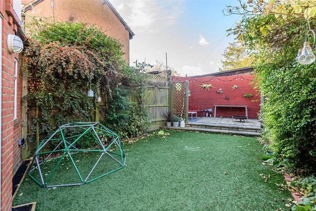 The rear garden has been well landscaped with a plant border and artificial grass that leads to the decking area