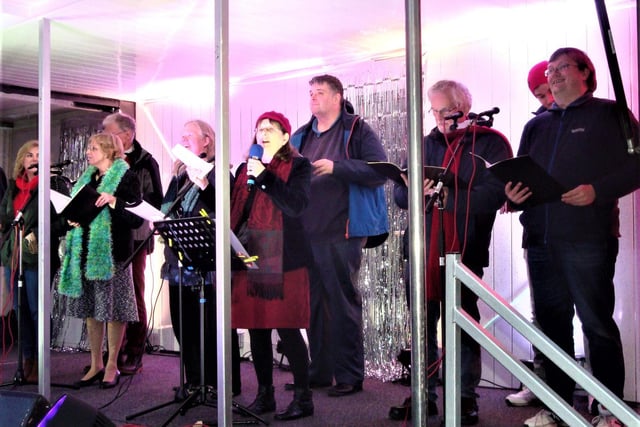 Baptist Music Group leader Laura Kisby introduces a song at the switch-on of the Rotary Club of Royal Leamington Spa's tree of light in Leamington.