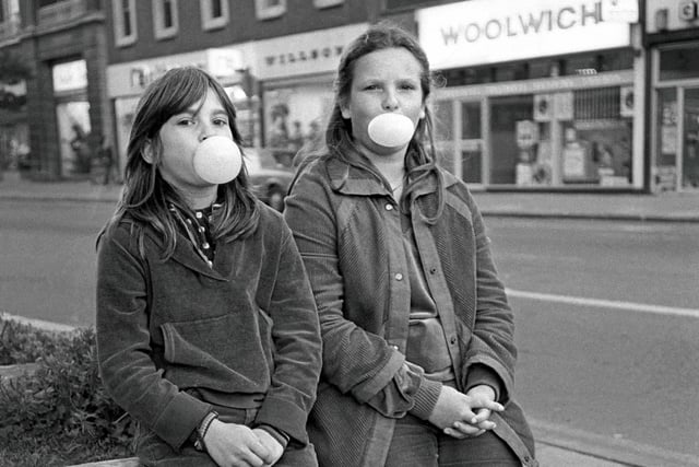 Anna and Emma Hankins blowing bubbles with Hubba Bubba chewing gum in Bridge Street in 1980.