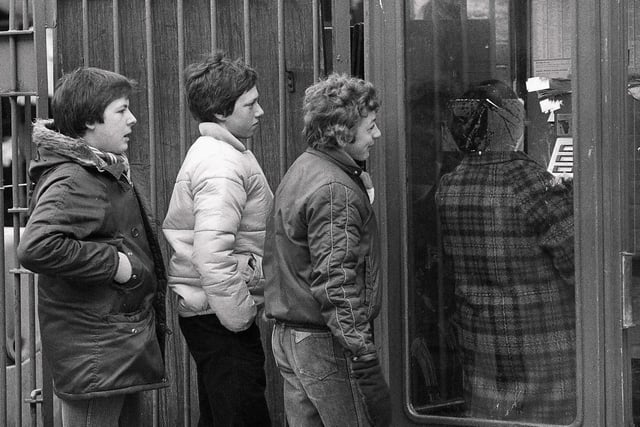 John Morris, Paul Barnard and Andrew Pollard  queuing up to use the phone in Cattle Market Road in 1981