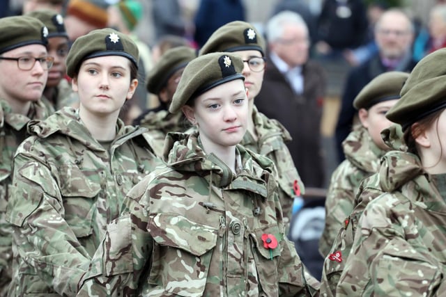 Army cadets march past the war memorial