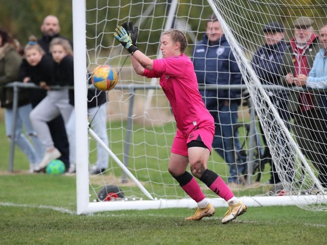 Izzy McDonald makes the decisive penalty save to send Cobblers through.