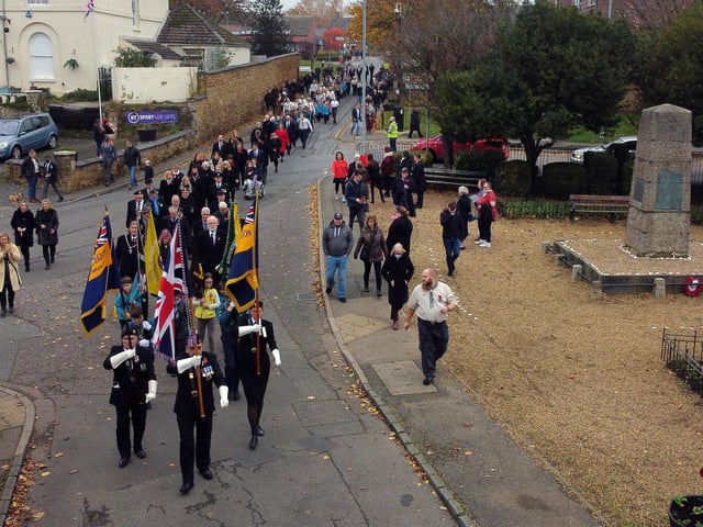 The remembrance parade makes it way to St Giles Church in Desborough.