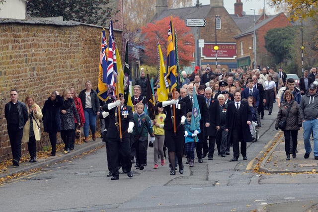 The remembrance parade makes it way to St Giles Church in Desborough.