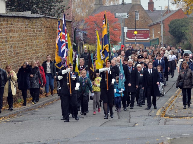 The remembrance parade makes it way to St Giles Church in Desborough.