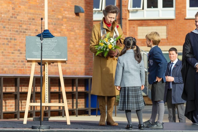 The Princess receives a posy from Warwick Preparatory School pupil, Olivia and Warwick Junior School pupil, Teddy