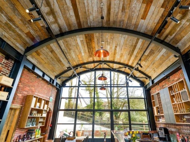 Another view of the tasting room with its impressive arched window and wooden ceiling SUS-211116-083249001