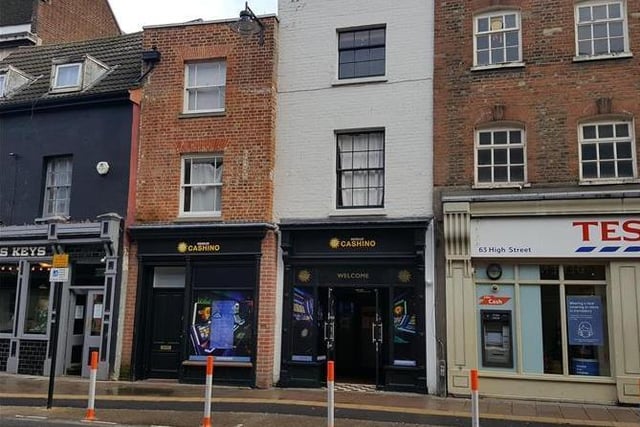 This shop in Bedford's High Street is open plan and has an enclosed rear yard, It also boasts a mixed use of investment with four 1-bedroom flats on the first and second floors