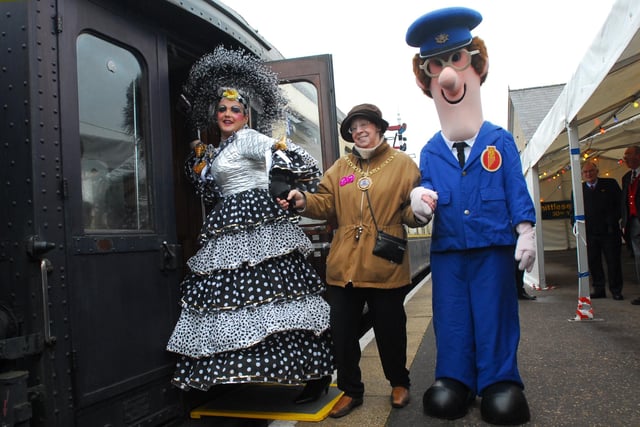 Mayor Pat Nash climbing on board with dame from Aladdin panto and Postman Pat