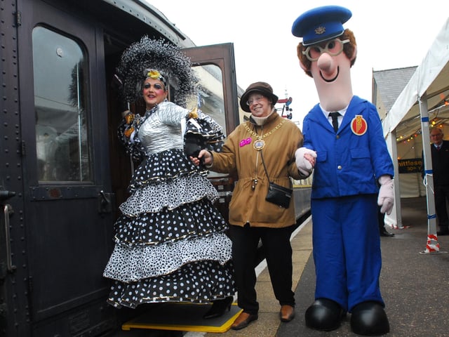Mayor Pat Nash climbing on board with dame from Aladdin panto and Postman Pat