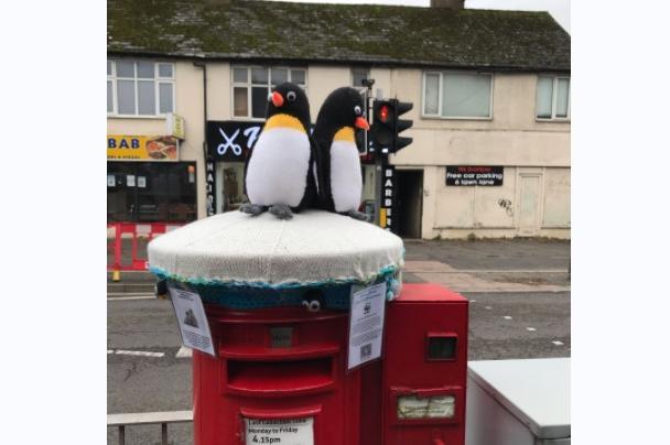 There are penguins on this postbox topper