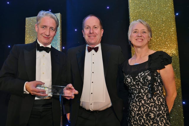 Peterborough Telegraph Business Excellence Awards 2021. Large   Business  Person of the Year winner   Paul Holt with sponsor  Andrew Hornsby and Ann Daniels. EMN-211120-003541009