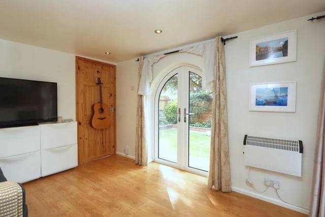The open plan annexe features arched windows and French doors