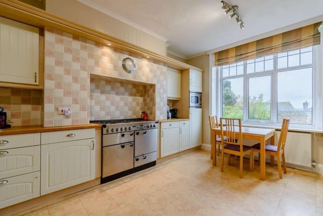 The kitchen and breakfast room has a walkin larder, an adjoining utility room, plenty of storage in cream-coloured units to base and wall level and a stainless steel range cooker. SUS-211124-114724001