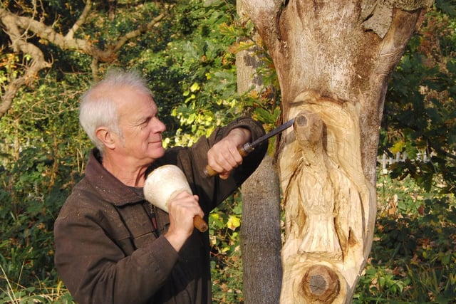 Wood carver Graham Jones making a sculpture in Priory Park. Photo by Geoff Ousbey