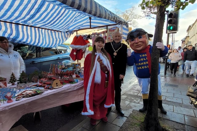 Mayor of Skegness Coun Trevor Burnham, Skegness Carnival Queen and the Jolly Fisherman checking out the stalls at the Christmas Market.