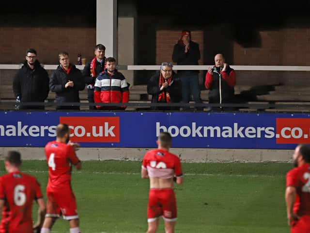 The Kettering players applaud their fans at full-time