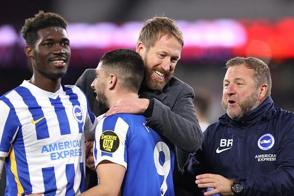 Graham Potter celebrates with Neal Maupay, Yves Bissouma and assistant Billy Reid