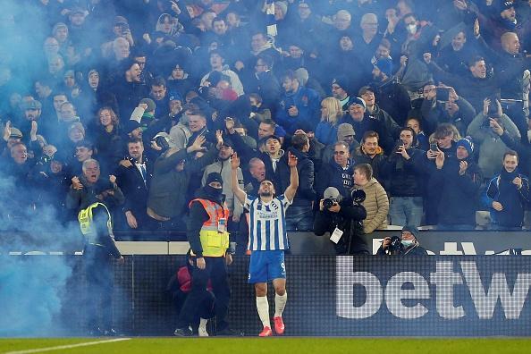 Brighton fans celebrate with Neal Maupay