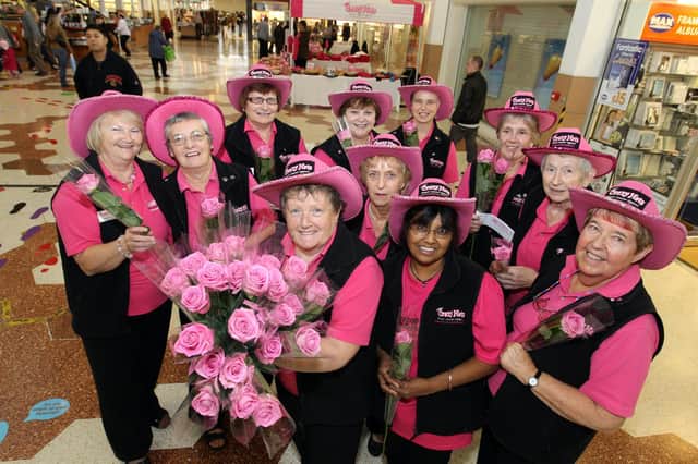 The Crazy Hats team in 2012 fundraising in Wellingborough's Swansgate centre for Breast Cancer Awareness Week. Glennis Hooper founder with Crazy Hats volunteers. October 2012