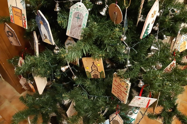 The Friends of St John the Baptist Church Findon are raising money to repair the church door, so took the theme of doors for their Christmas Tree