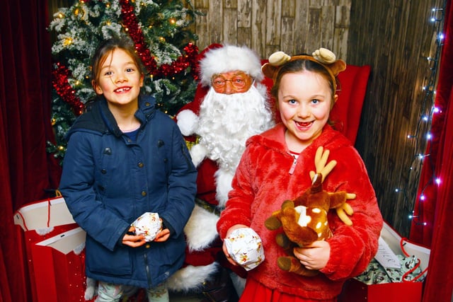 Alba St John-Hilton, left and Hope Jenkins both 6 with Santa. Photo by Derek Martin Photography and Art. SUS-210312-202948008
